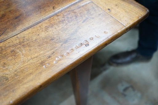 An early 19th century French rectangular fruitwood kitchen table fitted two drawers, length 201cm, depth 80cm, height 76cm